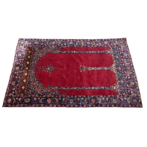 392 - AN ISFAHAN SILK PRAYER RUG 20th century, with a claret field and foliate borders, 228cm x 136cm