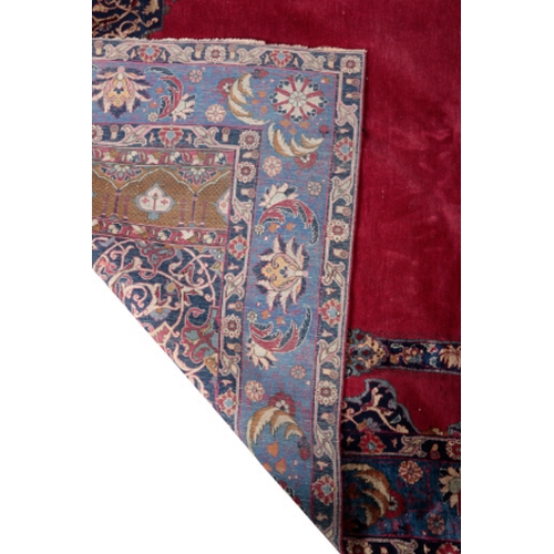 392 - AN ISFAHAN SILK PRAYER RUG 20th century, with a claret field and foliate borders, 228cm x 136cm