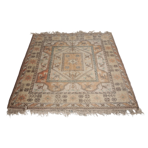 394 - AN ANATOLIAN RUG woven in muted colours with square medallion and geometric motifs within concentric... 