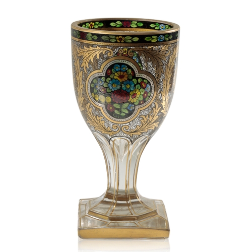 589 - JULIUS MUHLHAUS & CO: A GILDED AND TRANSMALEREI GLASS GOBLET decorated with floral cartouches agains... 