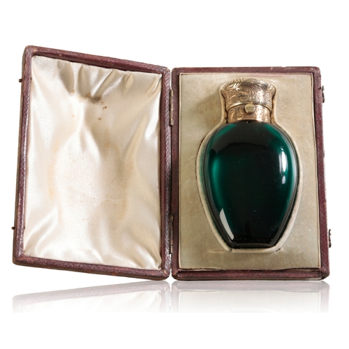 596 - HOWELL & JAMES: A SILVER MOUNTED EMERALD CRYSTAL SCENT BOTTLE the ovoid body mounted with a spring a... 