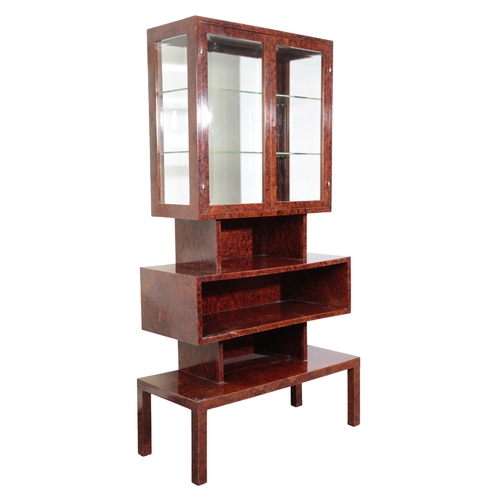 688 - AN ART DECO DISPLAY CABINET veneered with figured burr elm, the upper section glazed to all sides wi... 