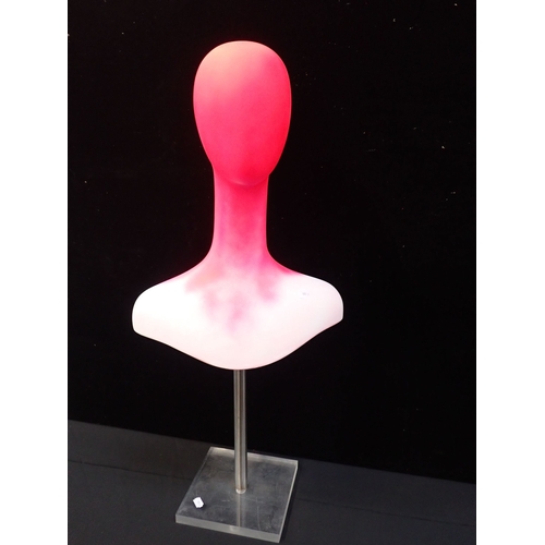 101 - A PINK PAINTED PLASTIC DISPLAY HEAD with steel and perspex stand, 85cm high.