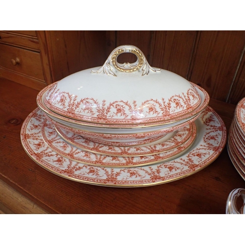 144 - A ROYAL WORCESTER PART DINNER SERVICE in a floral swag transfer, with gilt rims and handles