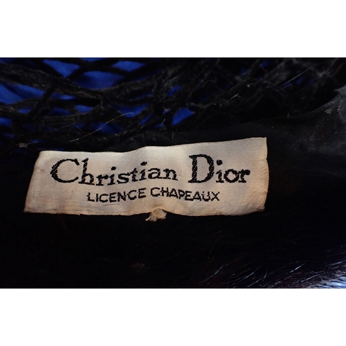 152 - CHRISTIAN DIOR: A BLACK FUR SCULL CAP/ HAT with diamante arrow decoration, some shedding