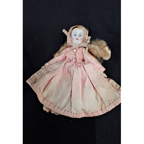 422 - A EDWARDIAN BISQUE DOLL together with a small baby doll with crochet clothing