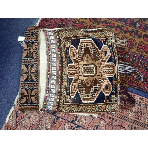 565 - AN ANTIQUE BELUCH DOUBLE SIDED SADDLEBAG woven in tan, brown and white with cruciform motifs on a bl... 