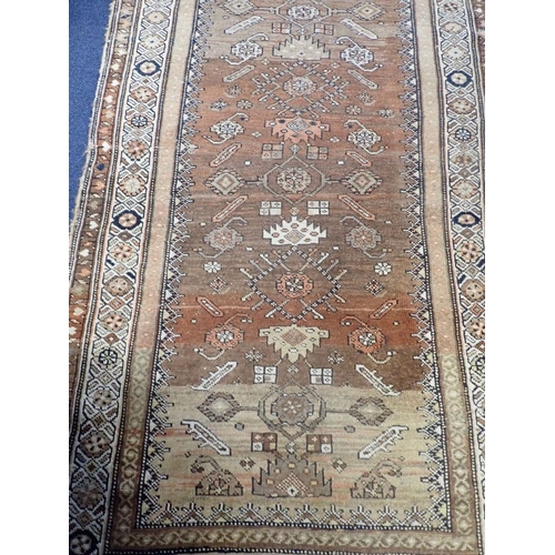 566 - AN ANTIQUE TURKISH RUNNER woven in colours with lozenge and geometric motifs on a yellow and rust co... 