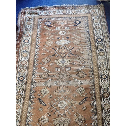 566 - AN ANTIQUE TURKISH RUNNER woven in colours with lozenge and geometric motifs on a yellow and rust co... 