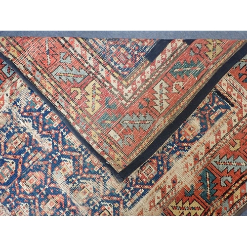 568 - AN ANTIQUE SHIRVAN RUNNER woven in colours with endless boteh repeat on a dark blue ground within wi... 