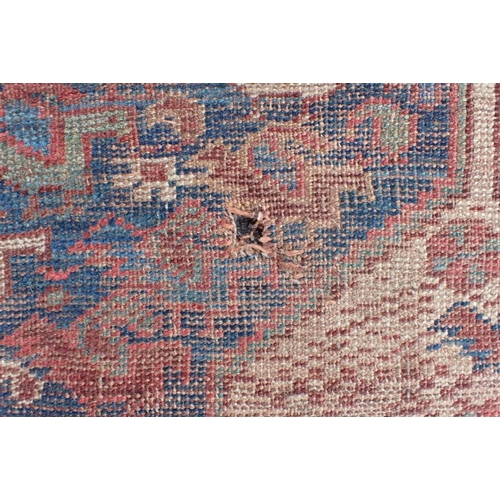 570 - AN ANTIQUE SHIRAZ CARPET woven in colours and white with two links rows of seven lozenge medallions,... 