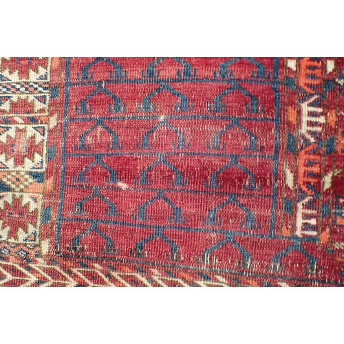 571 - AN ANTIQUE TURKMEN ENNSI woven in muted colours and white with traditional geometric pattern on a co... 