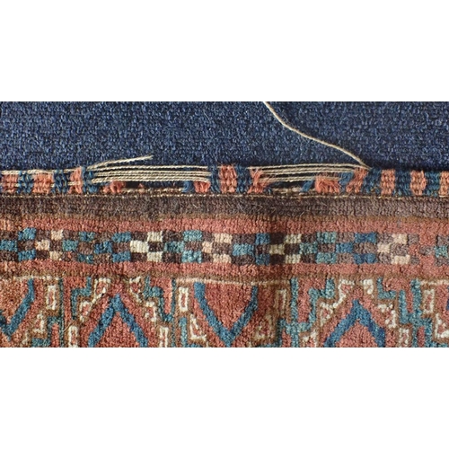 578 - AN ANTIQUE TURKMEN RUG woven in blue, red and white with endless gul repeat on a brown ground, withi... 