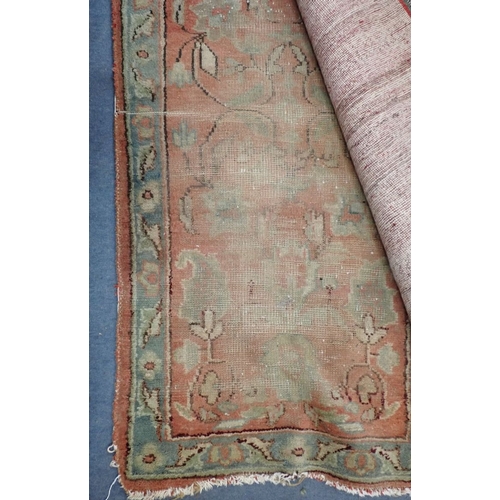 580 - A BERBER STYLE RUNNER the abrash mushroom field woven with scattered camel motifs and signed, within... 