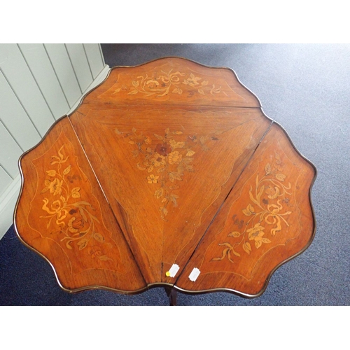 619 - A FRENCH ROSEWOOD TRIANGULAR OCCASIONAL TABLE with drop flaps to each side, with marquetry and gilt ... 