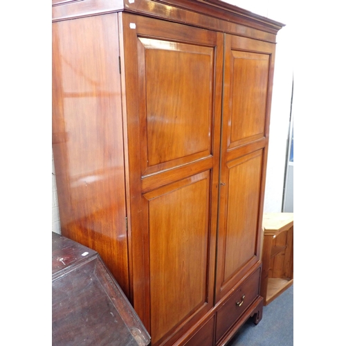 667 - AN EDWARDIAN MAHOGANY WARDROBE with fielded panelled doors, of George III style 130cm wide at cornic... 