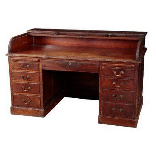 669 - A 1920S MAHOGANY ROLL TOP DESK the kneehole base fitted twin slides and nine drawers, 94cm high x 15... 