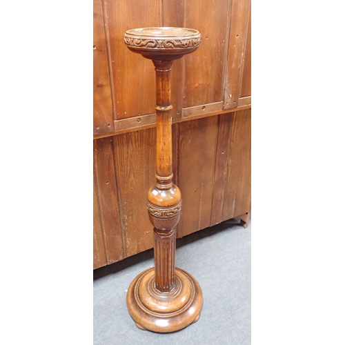 674 - A 1920S TURNED AND CARVED OAK TORCHERE or plant stand 120cm high