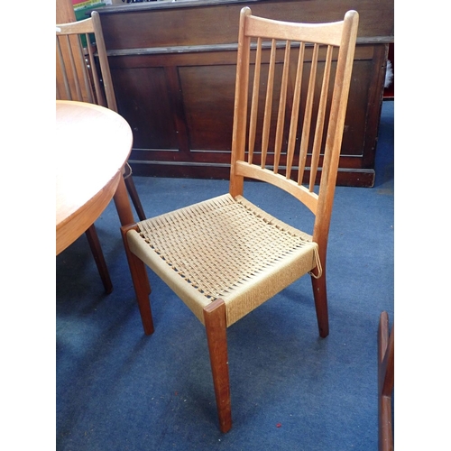 676 - A MID-CENTURY MODERN TEAK DINING TABLE AND SIX CHAIRS the 61cm circular table extending with two lea... 