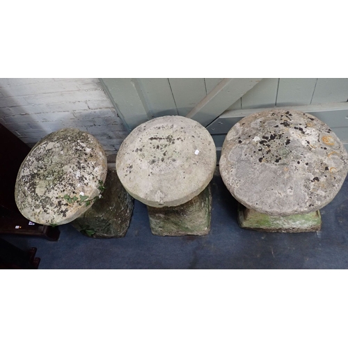 13 - THREE SIMILAR STADDLE STONES of typical form, 64cm, 66cm, and 69cm high (caution; VERY HEAVY)