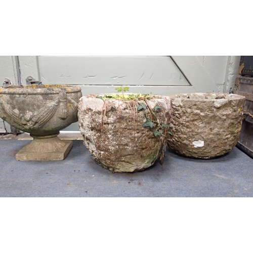 16 - TWO SIMILAR RUSTIC STONE GARDEN PLANTERS 28cm and 29cm high, and a reconstituted stone urn (3)