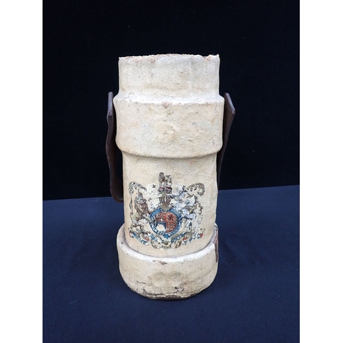 22 - A PAINTED CANVAS CORDITE OR SHOT CARRIER with transfer armorial and leather handle 33cm high (a/f)