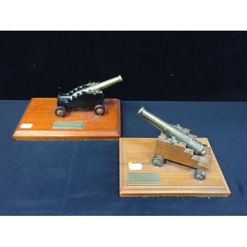 48 - TWO BRASS MODEL CANNON, ON WOODEN CARRIAGES mounted on presentation bases 19.5cm and 23.5cm wide (ba... 