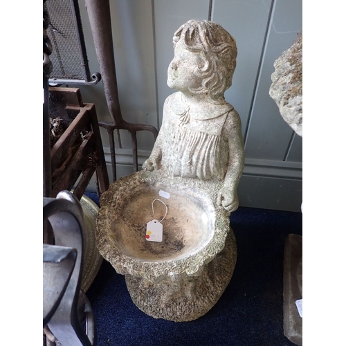 9 - A RECONSTITUTED STONE BIRD BATH the basin of tree stump form, with a girl standing behind 54cm high