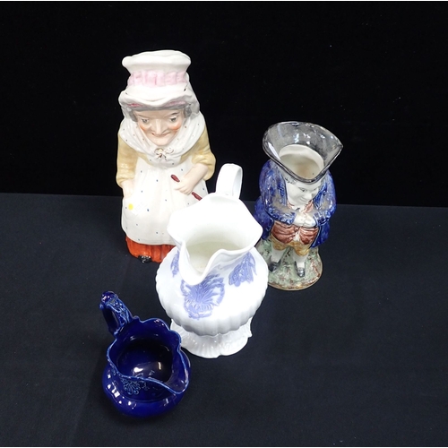 77 - A VICTORIAN 'MRS PUNCH' JUG with cover, a Toby jug, and two other jugs (4)