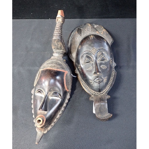 87 - TWO AFRICAN MASKS, ONE SURMOUNTED BY A CHICKEN with some surface patination 41cm and 39cm