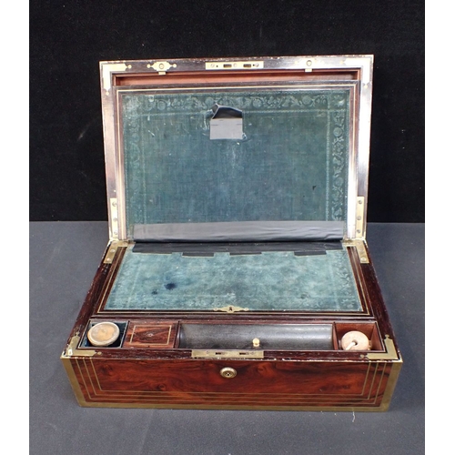 167 - A 19TH CENTURY ROSEWOOD AND BRASS BOUND WRITING SLOPE with fitted interior and Bramah lock (with key... 