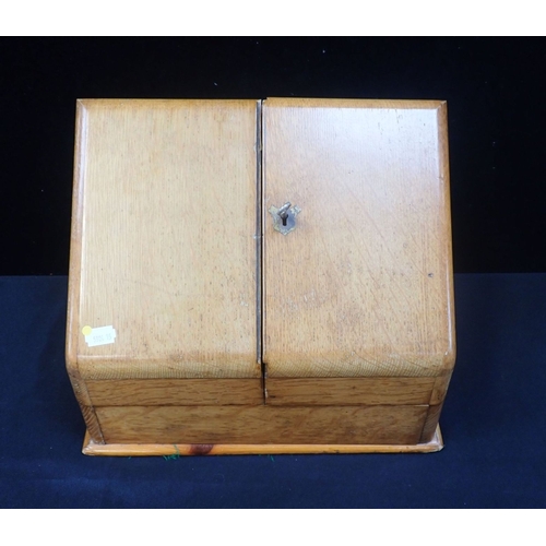 177 - AN EDWARDIAN GOLDEN OAK STATIONERY BOX with typical fitted interior (with key) (the bottom board and... 