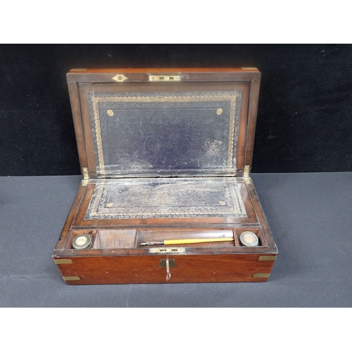 189 - A 19TH CENTURY BRASS-MOUNTED MAHOGANY WRITING SLOPE with fitted interior and patent inkwells