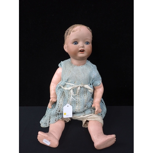 224 - AN ARMAND MARSEILLES BISQUE-HEADED DOLL composition limbs and body 51cm high