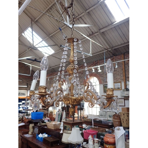 250 - A PAIR OF FIVE-BRANCH GILT METAL CHANDELIERS of Rococo design, with swagged prismatic drops 46cm hig... 