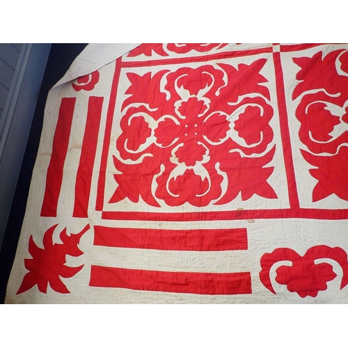 303 - A RED AND WHITE PATCHWORK QUILT, POSSIBLY AMERICAN hand-stitched 229 x 237cms (some marks and staini... 