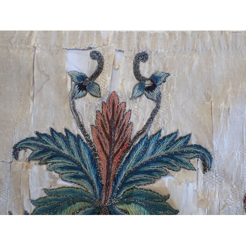 307 - AN 18TH CENTURY EMBROIDERED PANEL possibly fragment of bed hanging 104 x 47cms (damaged,couched onto... 