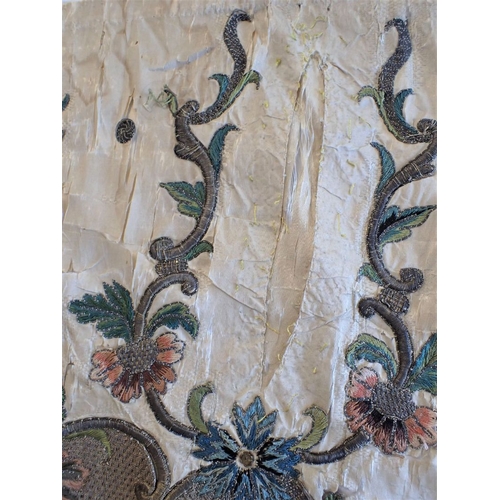 307 - AN 18TH CENTURY EMBROIDERED PANEL possibly fragment of bed hanging 104 x 47cms (damaged,couched onto... 