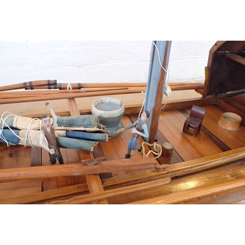 313 - AN EARLY 20TH CENTURY MODEL CHINESE JUNK with carved crew, purchased c.1920 by a Midshipman Tulloch,... 