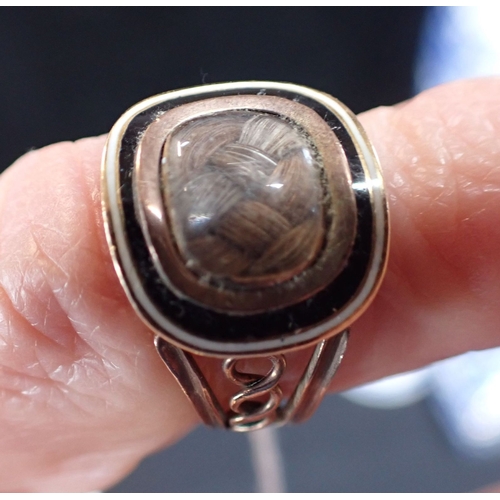 508 - A GEORGIAN MOURNING RING woven hair decoration with gold and enamel setting, and dated May 1810