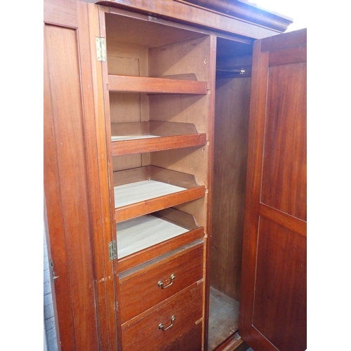 823 - A VICTORIAN MAHOGANY SINGLE WARDROBE the mirrored central door enclosing drawers and sliding trays 1... 