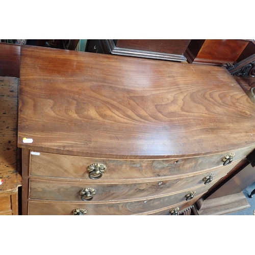 865 - A REGENCY MAHOGANY CHEST OF DRAWERS fitted four long drawers with stamped brass ring handles, on gad... 