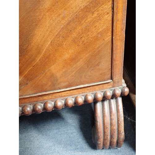 865 - A REGENCY MAHOGANY CHEST OF DRAWERS fitted four long drawers with stamped brass ring handles, on gad... 