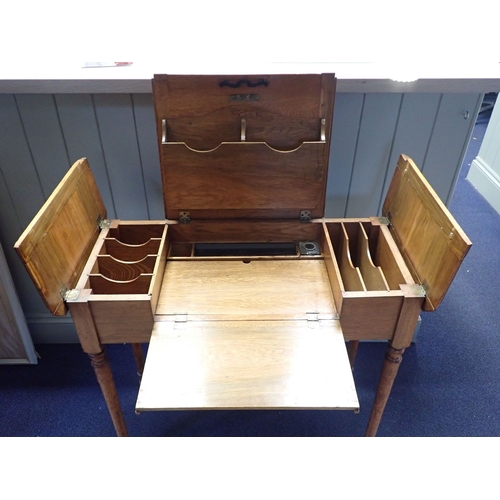 892 - A LATE 19TH CENTURY GOLDEN OAK PATENT DESK (name obscured), with lift-up top revealing fitted interi... 