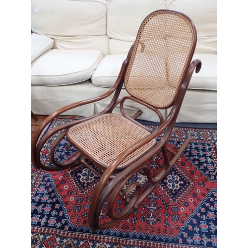 894 - A THONET STYLE BENTWOOD ROCKING CHAIR (unmarked) with renewed intact cane work (some splits to frame... 