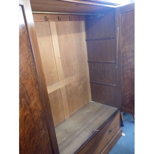 903 - AN EDWARDIAN FIGURED WARDROBE a pair of simple panelled doors over a deep drawer 130cm wide