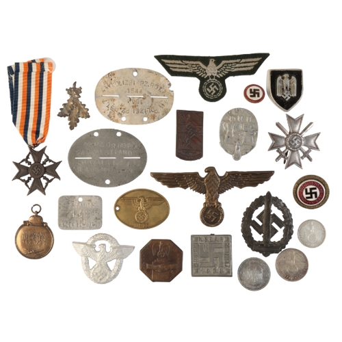 289 - A LARGE COLLECTION OF GERMAN BADGES AND MEDALS Mainly reproductions, dog tags, medals and badges. Wi... 