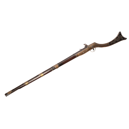 379 - A FLINTLOCK MUSKET with a full walnut stock, brass-bound floral decoration and steel ramrod, stamped... 