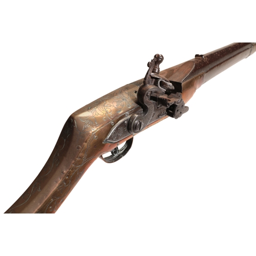 379 - A FLINTLOCK MUSKET with a full walnut stock, brass-bound floral decoration and steel ramrod, stamped... 