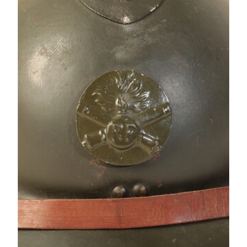 488 - A FRENCH ADRIAN HELMET WITH 'RF' BADGE in green olive paint with 'RF' badge. The helmet post WWI, li... 